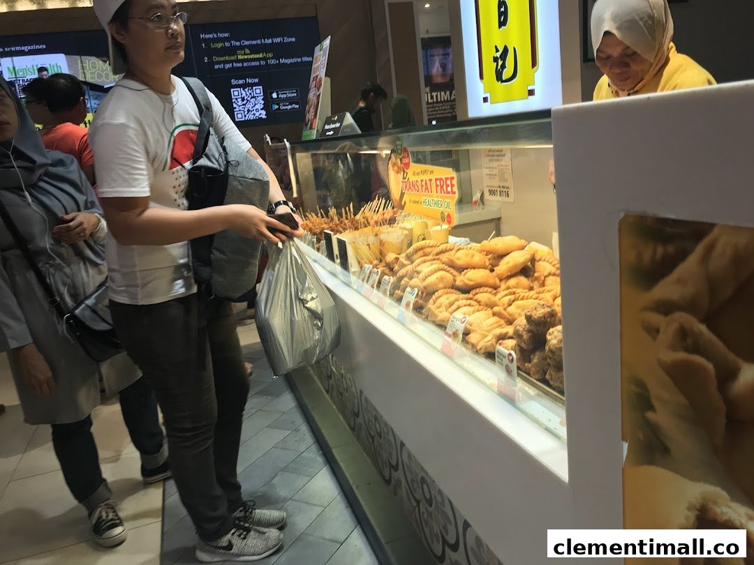 Customers browse a display of golden-fried snacks and pastries at Old Chang Kee.