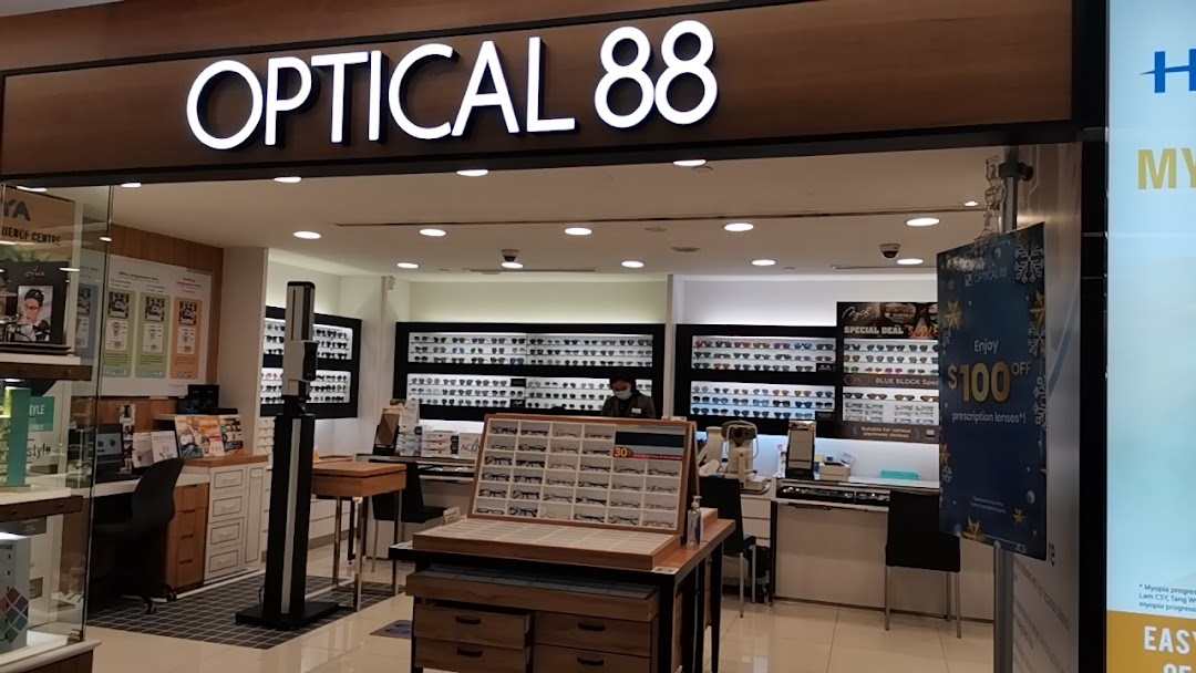 The brightly lit entrance of Optical 88, showcasing numerous eyewear displays and a welcoming interior.