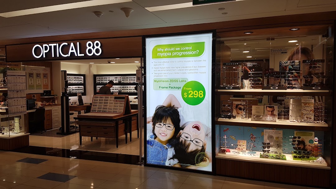 The storefront of Optical 88, featuring its illuminated sign, display windows, and a promotional poster.