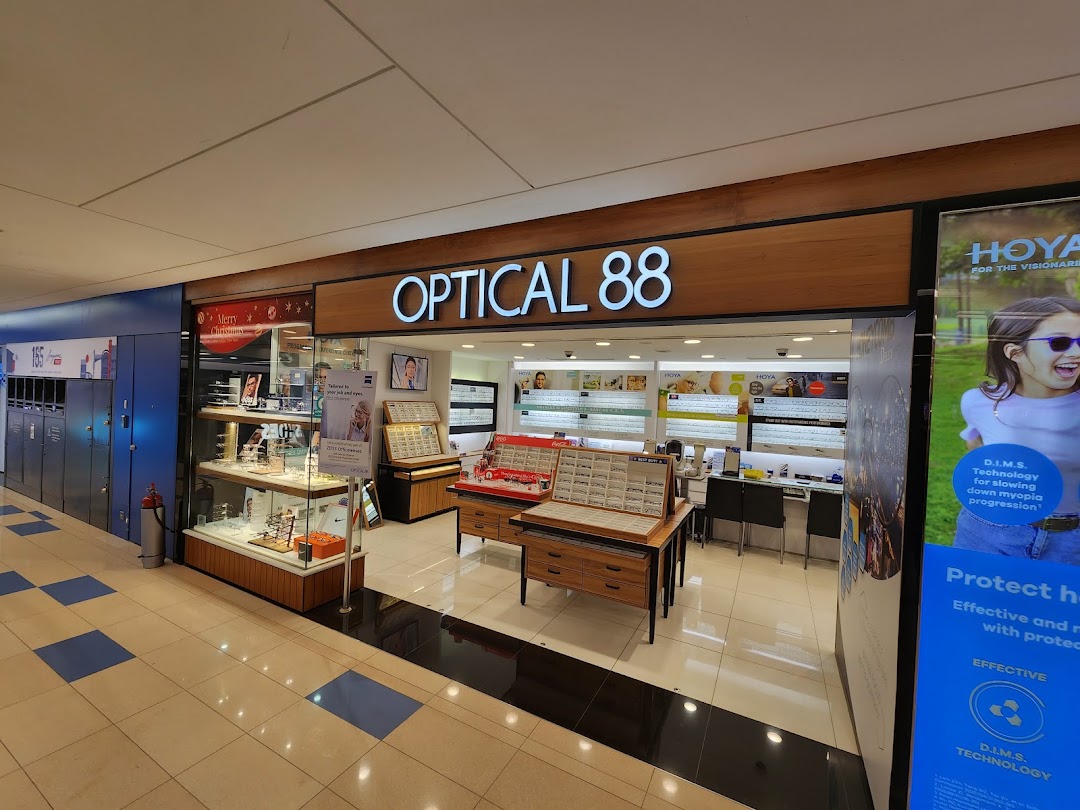 The storefront of Optical 88, showcasing its bright interior, eyewear displays, and prominent signage.