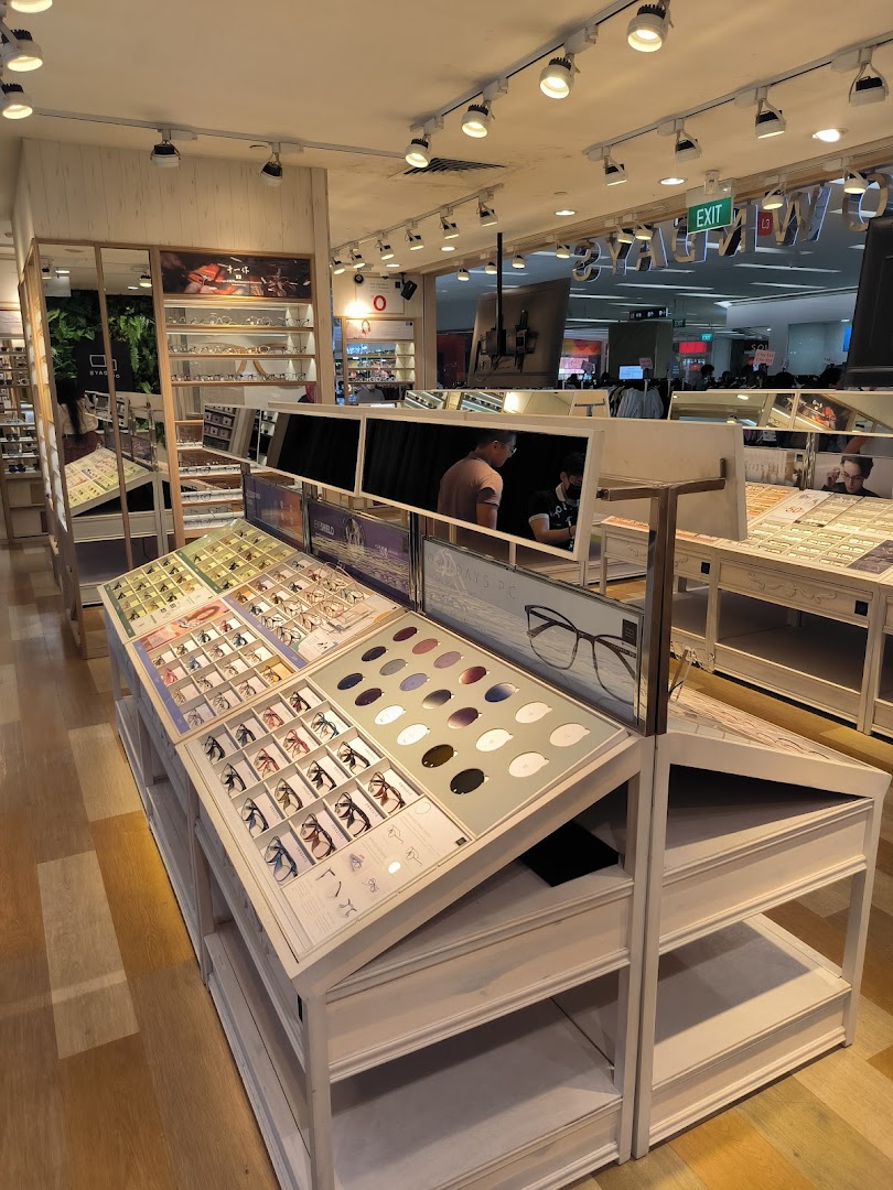 Interior view of OWNDAYS optical shop, showcasing diverse eyewear collections on modern display tables.