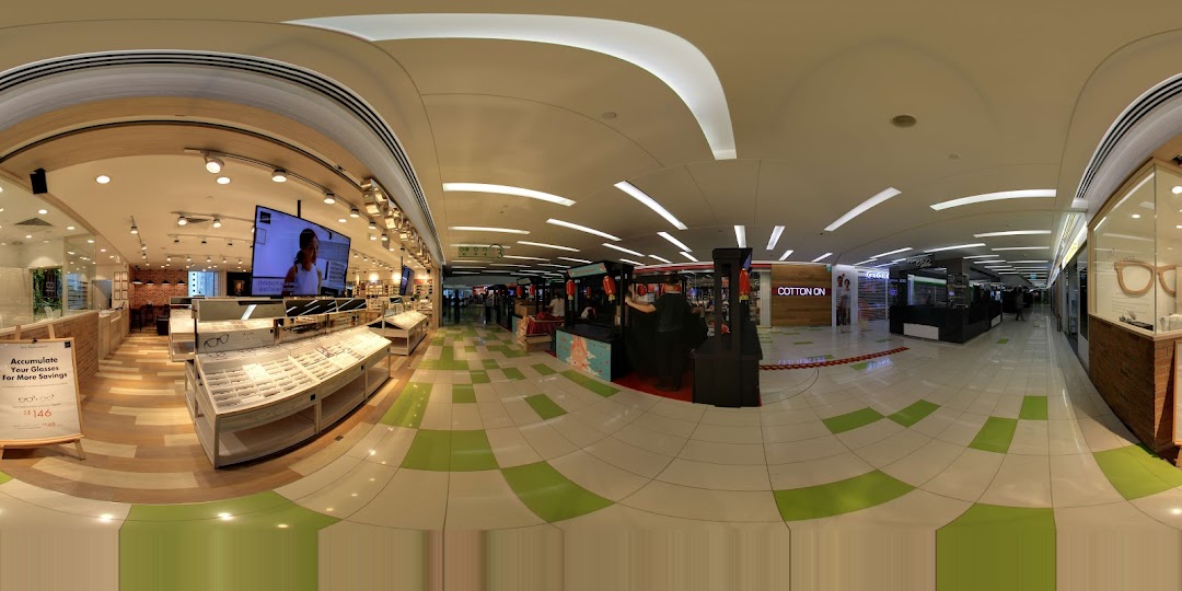 Interior view of OWNDAYS eyewear store, showcasing extensive frame displays and a large digital screen.