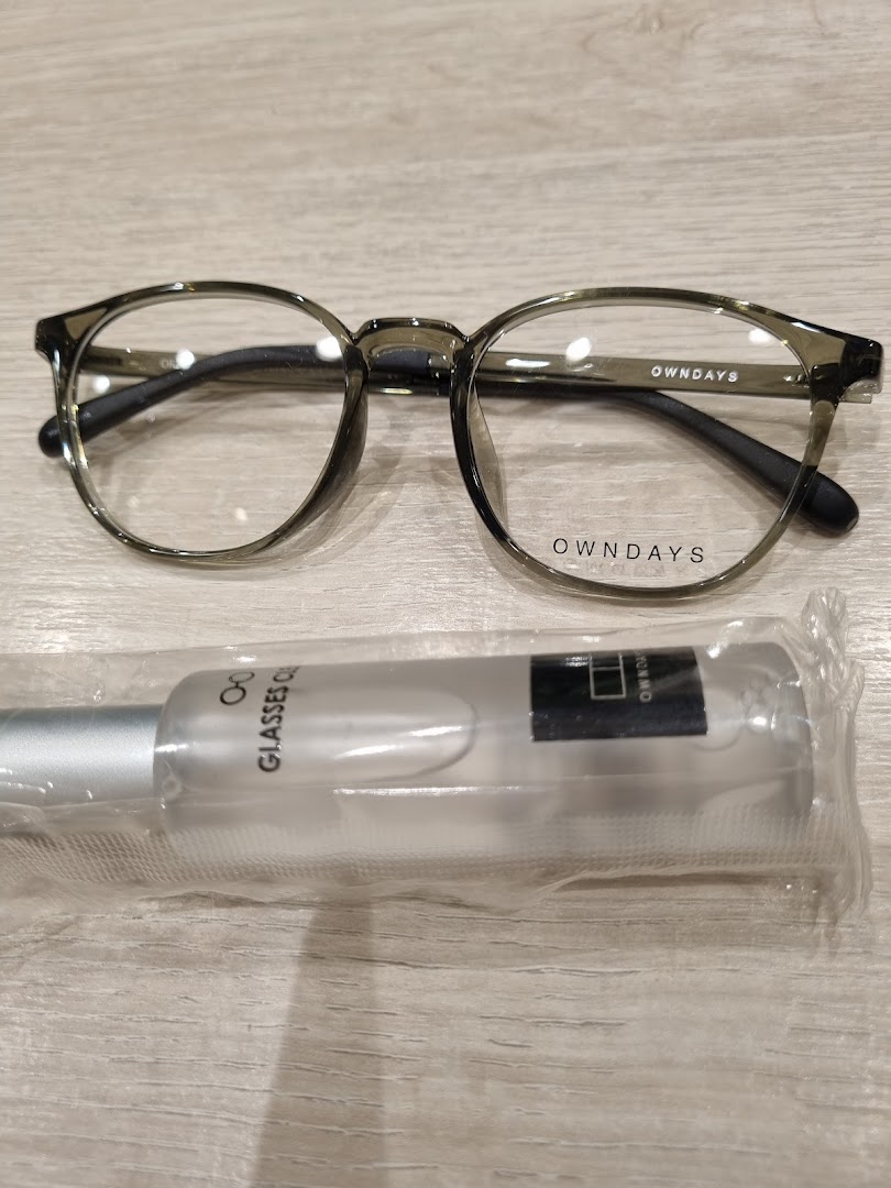 A stylish pair of OWNDAYS eyeglasses with a glasses cleaner spray.