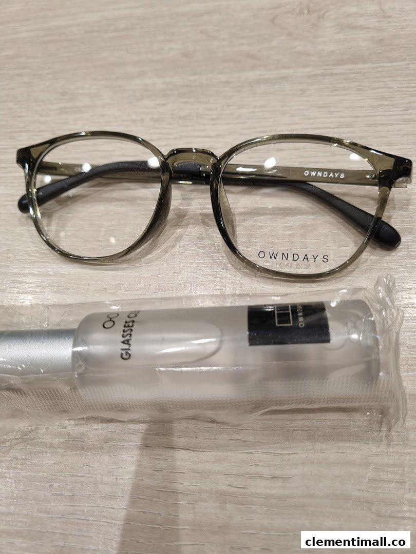 A stylish pair of OWNDAYS eyeglasses with a glasses cleaner spray.
