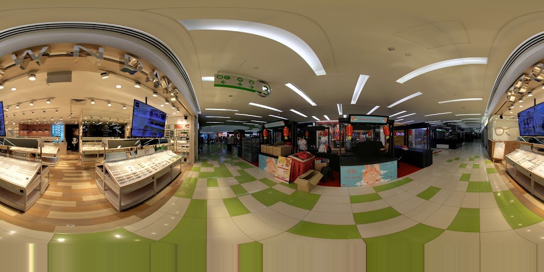 An interior panoramic view of OWNDAYS eyewear store, showcasing numerous glasses displays and a spacious layout.