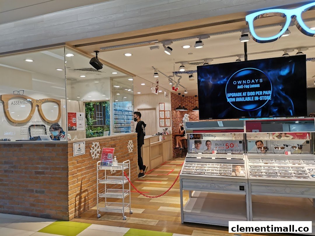 Interior view of OWNDAYS eyewear shop, showcasing product displays, a service counter, and promotional screens.
