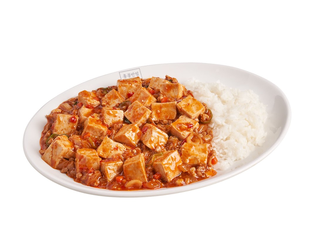 A white oval plate features a generous serving of spicy Mapo Tofu with white rice.