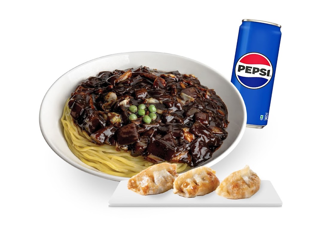 A delicious Korean Jajangmyeon noodle dish with fried dumplings and a refreshing Pepsi.