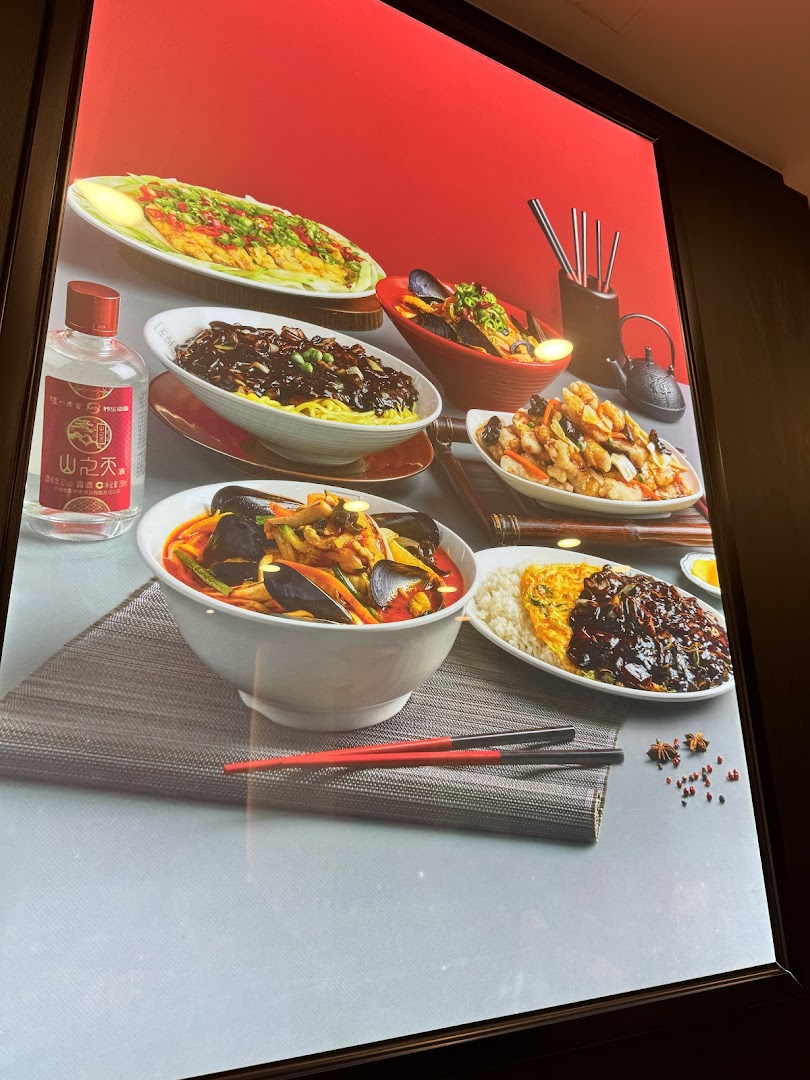 A vibrant display showcasing various Korean-Chinese dishes like Jajangmyeon, Jjamppong, and Tangsuyuk.
