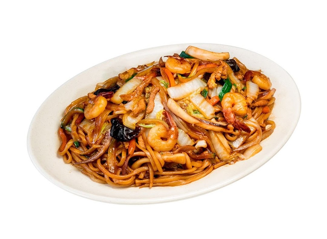 A close-up of a delicious plate of stir-fried noodles with seafood and vegetables.