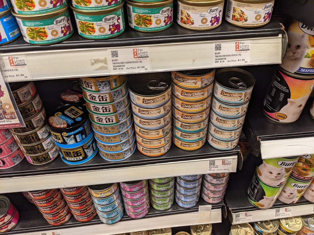 Shelves stocked with a wide variety of canned pet food products, primarily for cats.