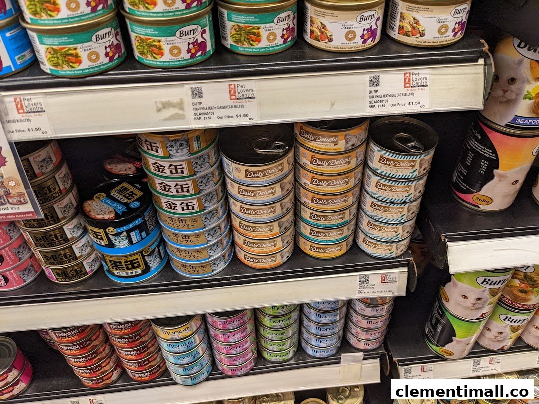 Shelves stocked with a wide variety of canned pet food products, primarily for cats.