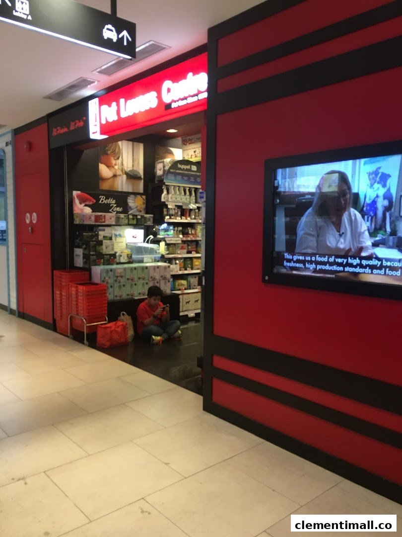The vibrant red and black storefront of Pet Lovers Centre, showcasing its entrance and interior.
