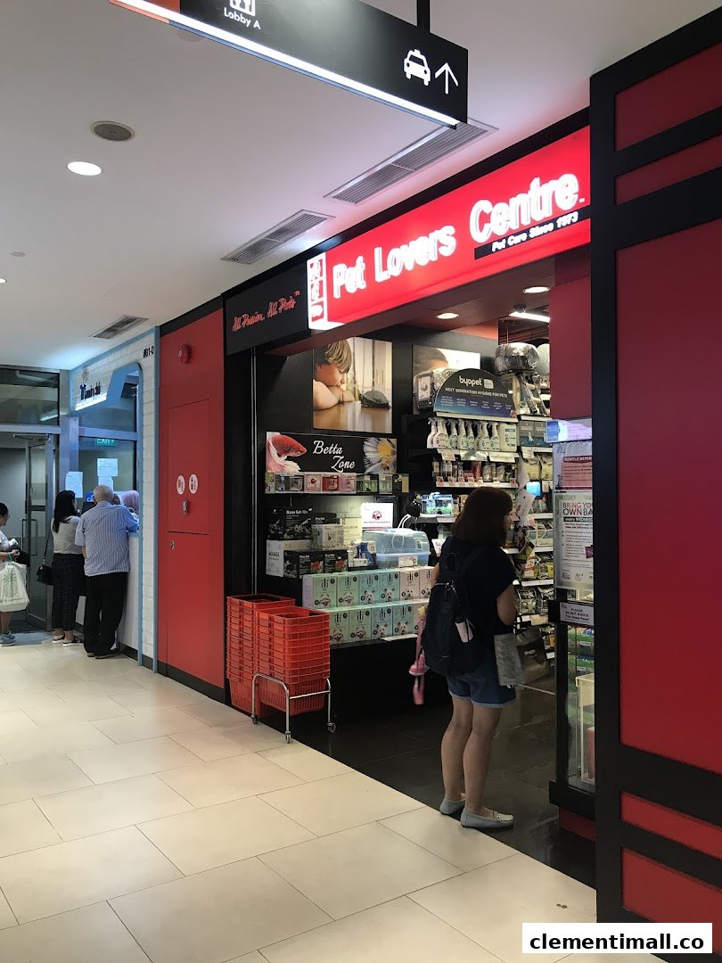 The vibrant red shop front of Pet Lovers Centre, showcasing its entrance and interior with pet supplies.