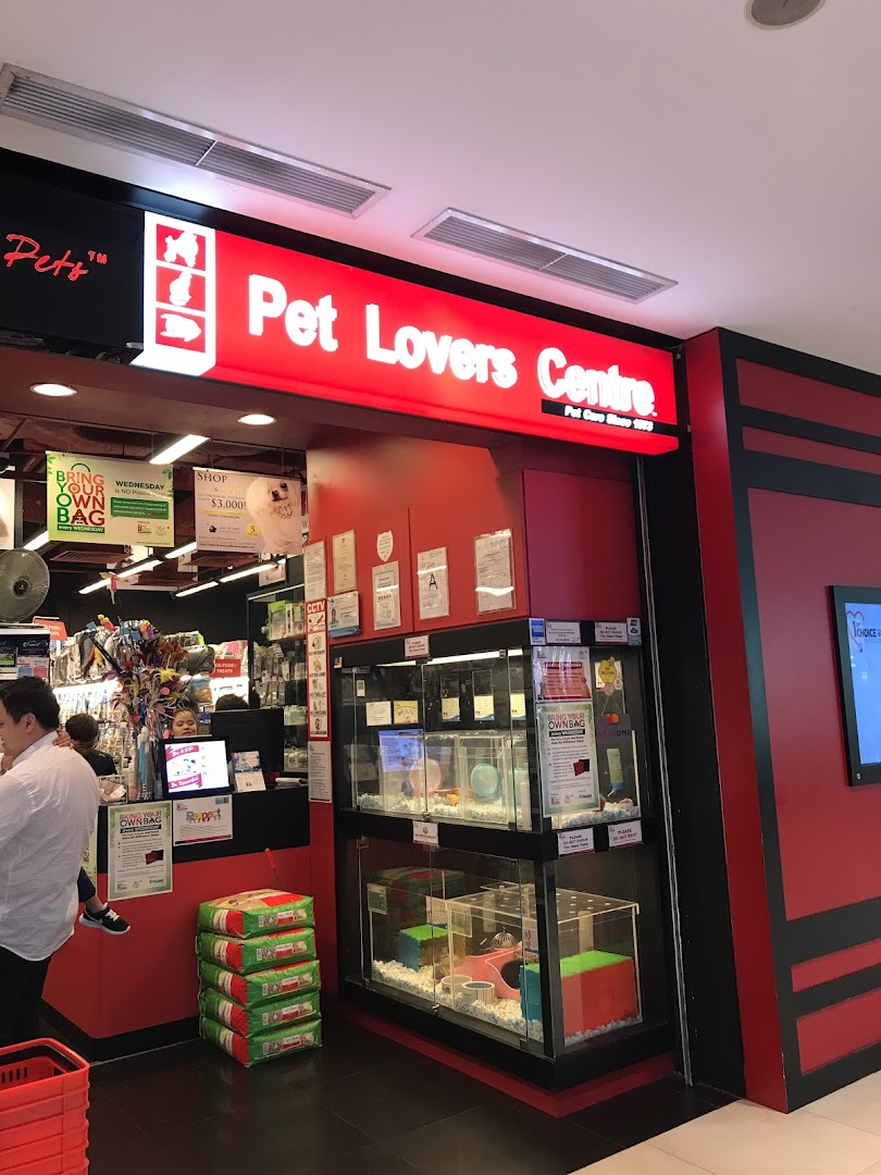 Entrance of Pet Lovers Centre, featuring its bright red signage, pet enclosures, and various pet supplies.