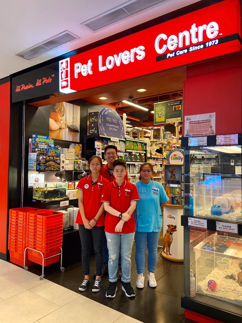 The storefront of Pet Lovers Centre with staff members and pet supplies visible inside.