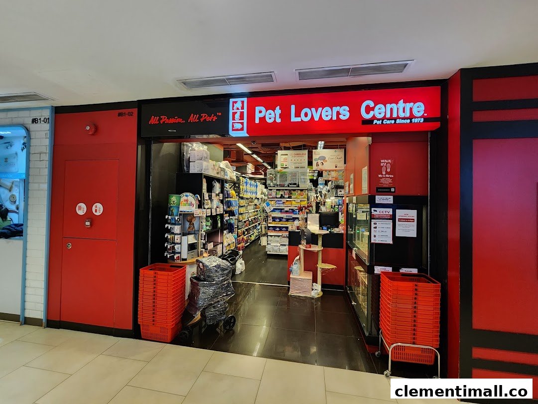 The vibrant red entrance of Pet Lovers Centre, a pet care store, showcasing its interior.