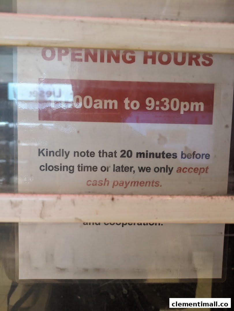 A sign displaying Pet Lovers Centre's opening hours and cash-only payment policy near closing time.