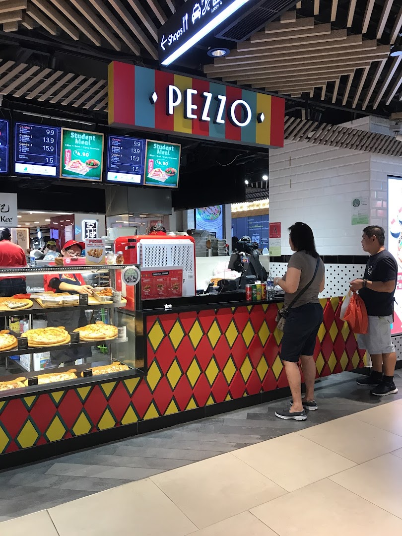 A vibrant Pezzo pizza counter showcasing freshly baked pizzas and menu boards.
