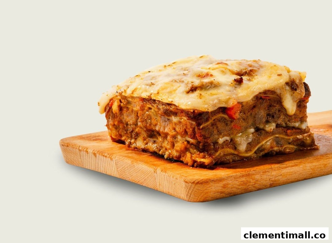A delicious, cheesy lasagna slice served on a wooden cutting board.