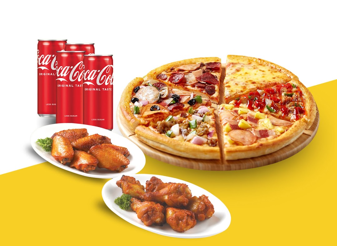 A vibrant image showcasing a multi-flavored pizza, crispy chicken wings, and Coca-Cola cans.