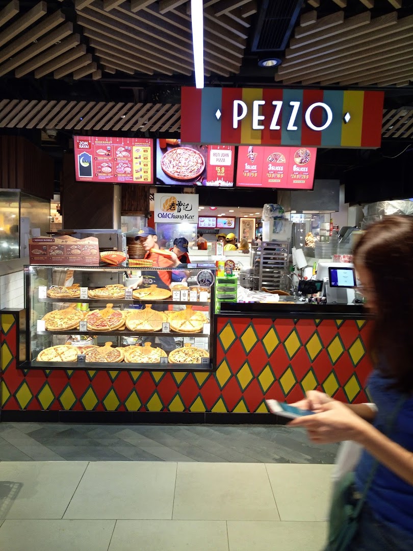 A vibrant Pezzo pizza counter showcasing fresh pizzas and digital menu boards in a mall setting.