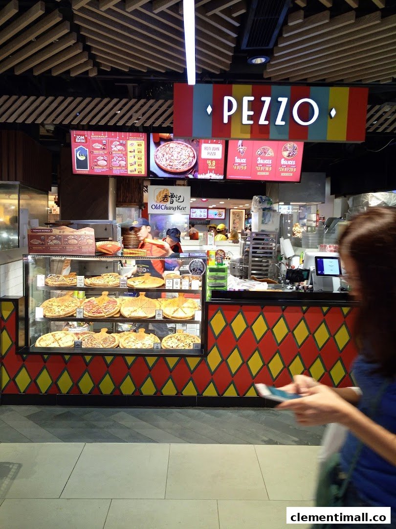 A vibrant Pezzo pizza counter showcasing fresh pizzas and digital menu boards in a mall setting.