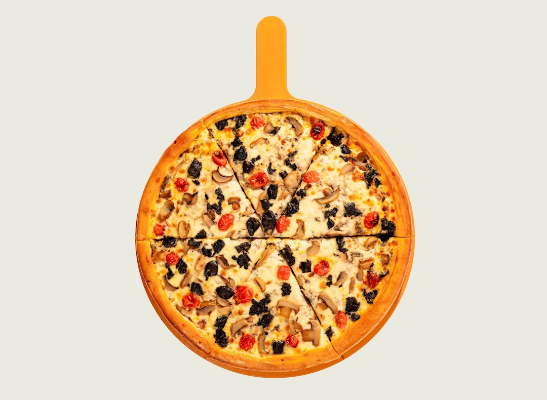 A delicious pizza with mushrooms, olives, and cherry tomatoes on a pizza peel.