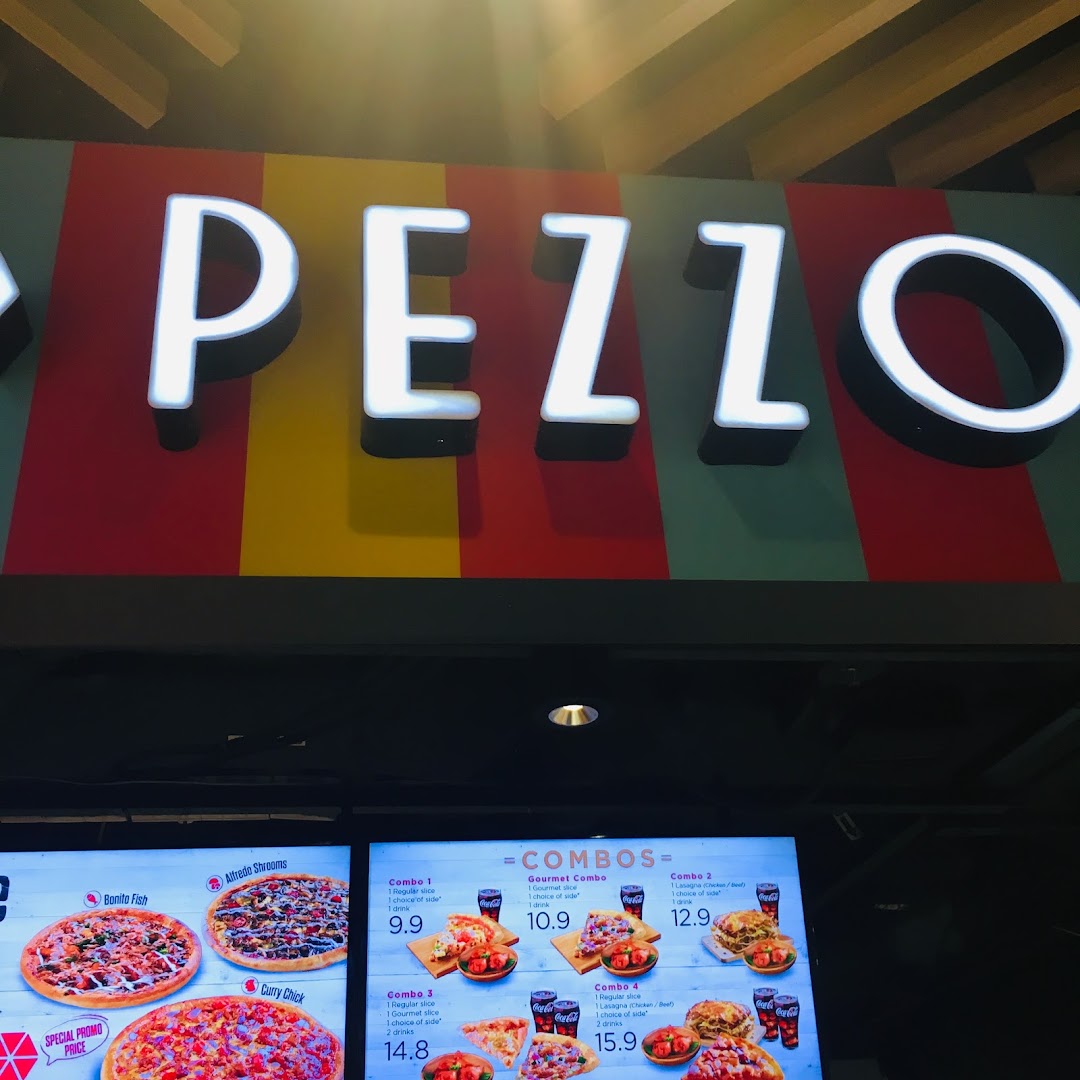 The Pezzo shop sign and a digital menu board displaying various pizza and combo meal options.