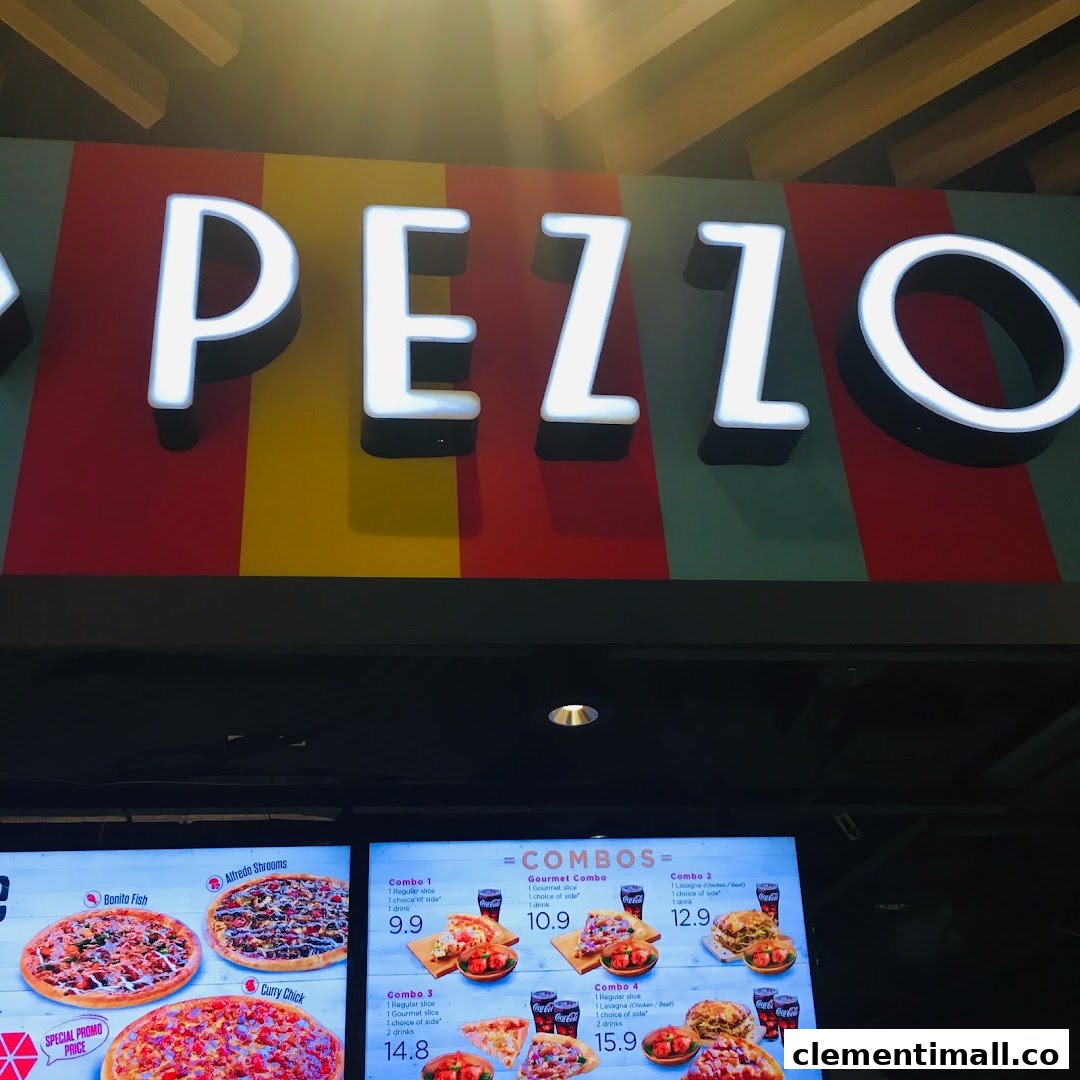 The Pezzo shop sign and a digital menu board displaying various pizza and combo meal options.