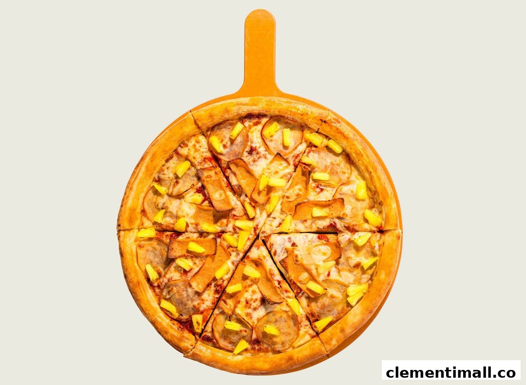 A whole pizza with pineapple and ham/bacon toppings, served on a wooden pizza peel.