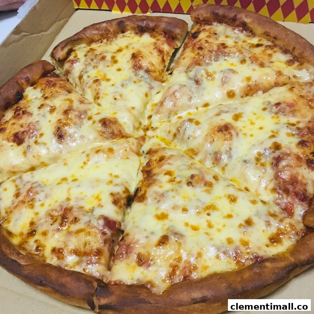A freshly baked cheese pizza with a thick crust, sliced and ready to eat in a box.
