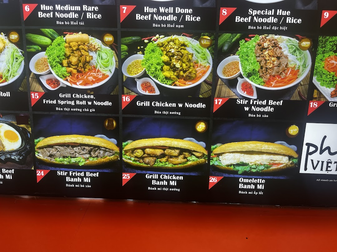 A vibrant menu board showcasing various Vietnamese noodle dishes and banh mi sandwiches.