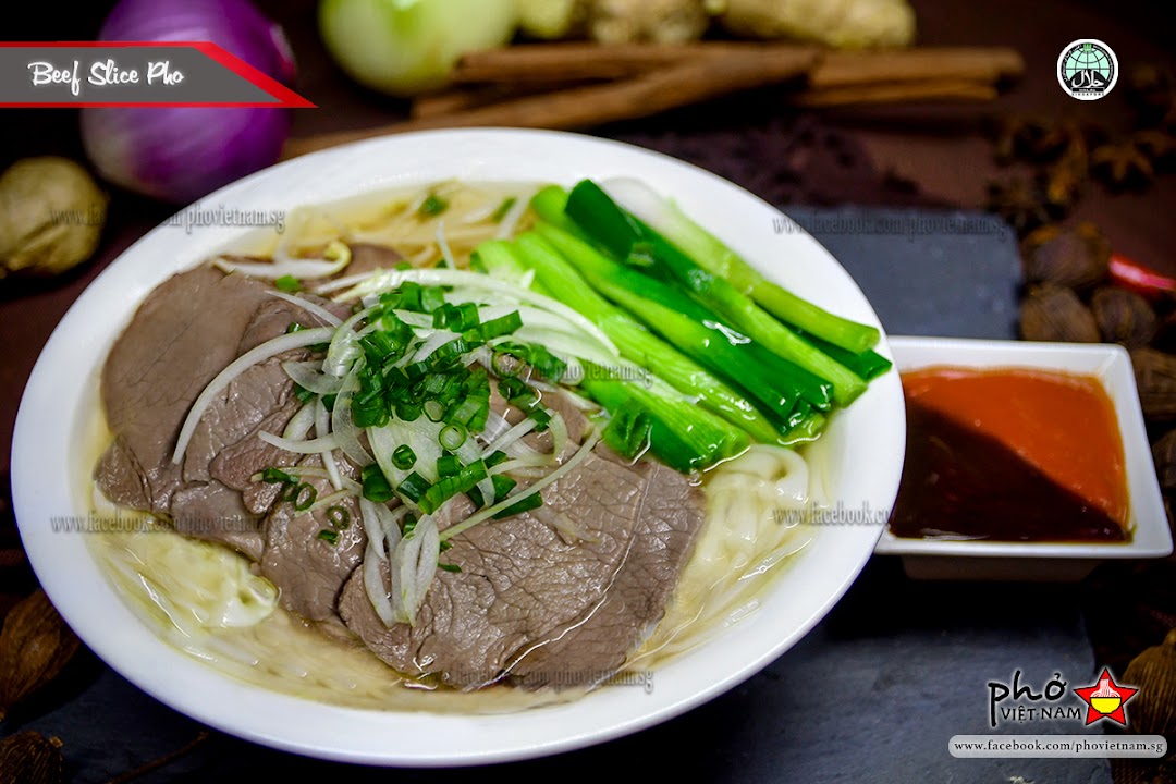 A delicious bowl of Beef Slice Pho with fresh garnishes and dipping sauce.