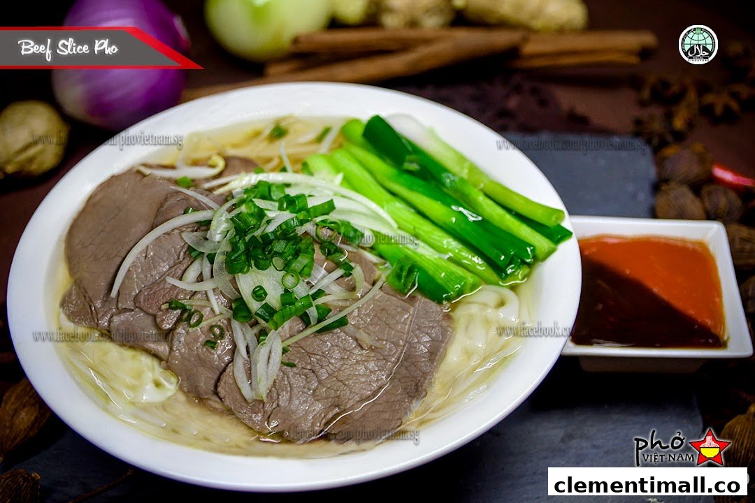 A delicious bowl of Beef Slice Pho with fresh garnishes and dipping sauce.