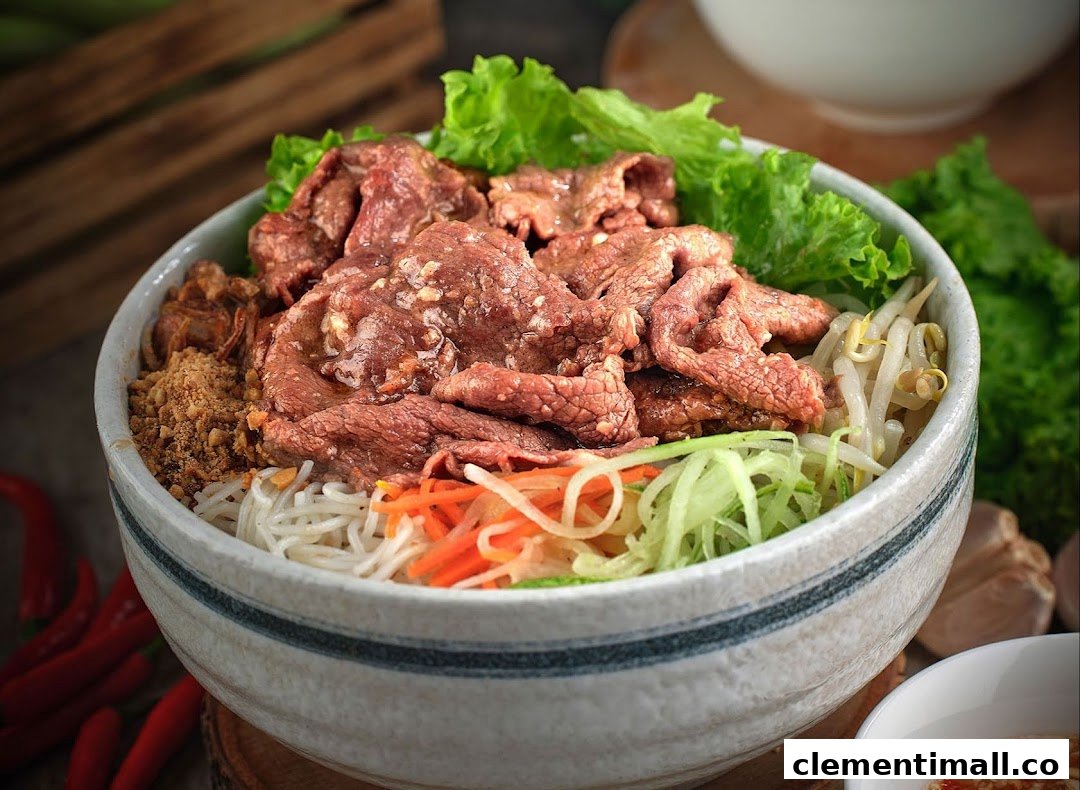 A close-up of a vibrant Vietnamese noodle bowl featuring beef, fresh vegetables, and peanuts.