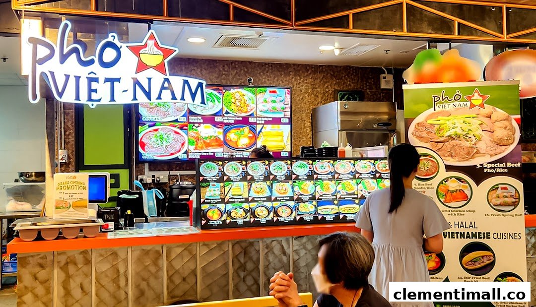 A vibrant Pho Vietnam food stall with digital menus and customers at the counter.