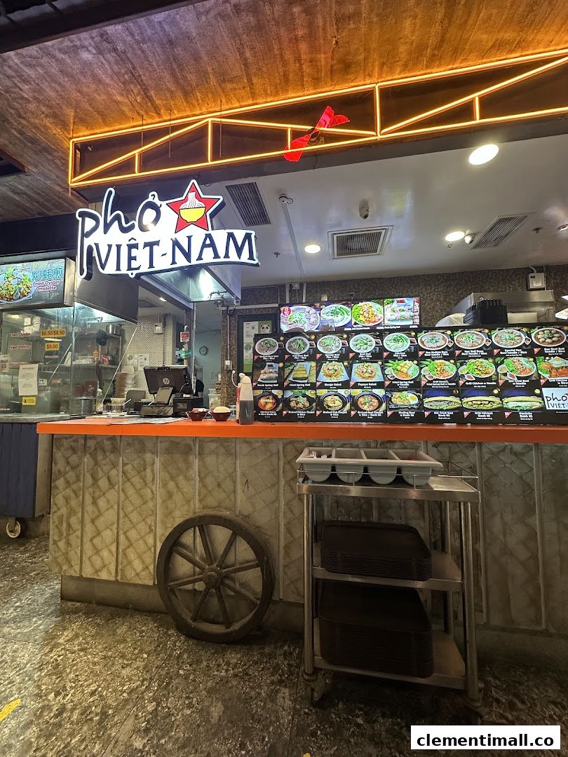 The counter area of Pho Vietnam, featuring its illuminated sign and digital menu displays.