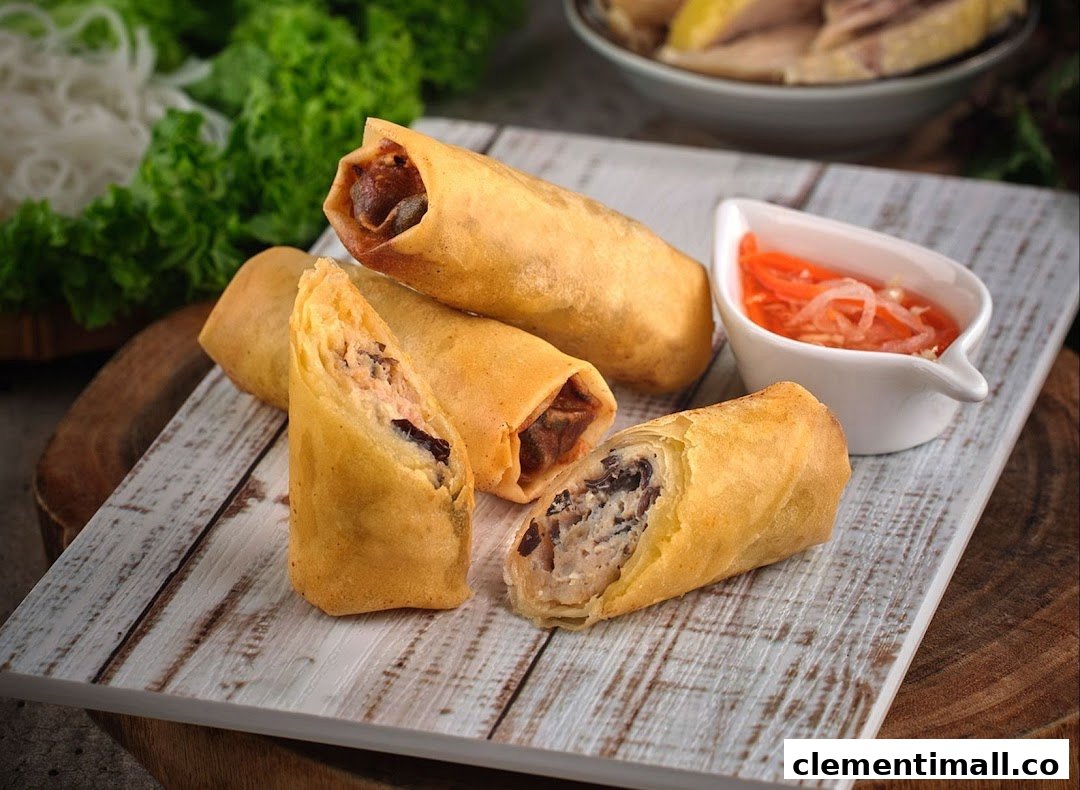 Crispy Vietnamese fried spring rolls served with a tangy dipping sauce on a rustic wooden board.