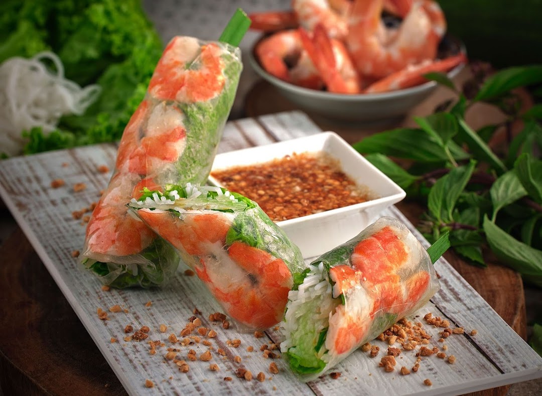 Three fresh Vietnamese spring rolls filled with shrimp, lettuce, and vermicelli, served with a peanut dipping sauce.