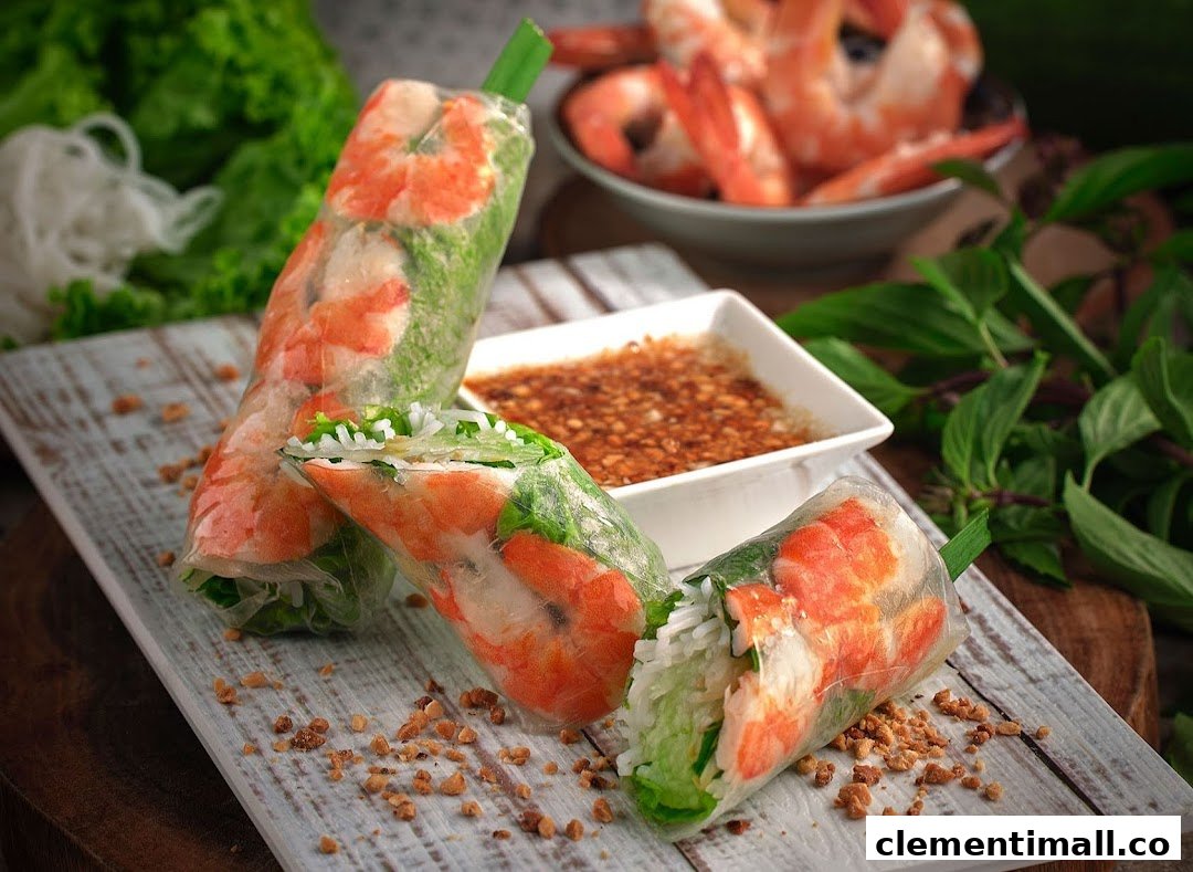 Three fresh Vietnamese spring rolls filled with shrimp, lettuce, and vermicelli, served with a peanut dipping sauce.