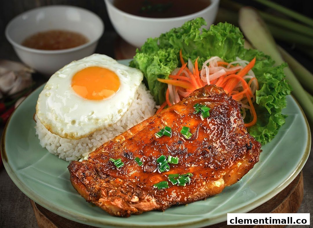 A vibrant Vietnamese dish featuring grilled chicken, rice, fried egg, and fresh vegetables.