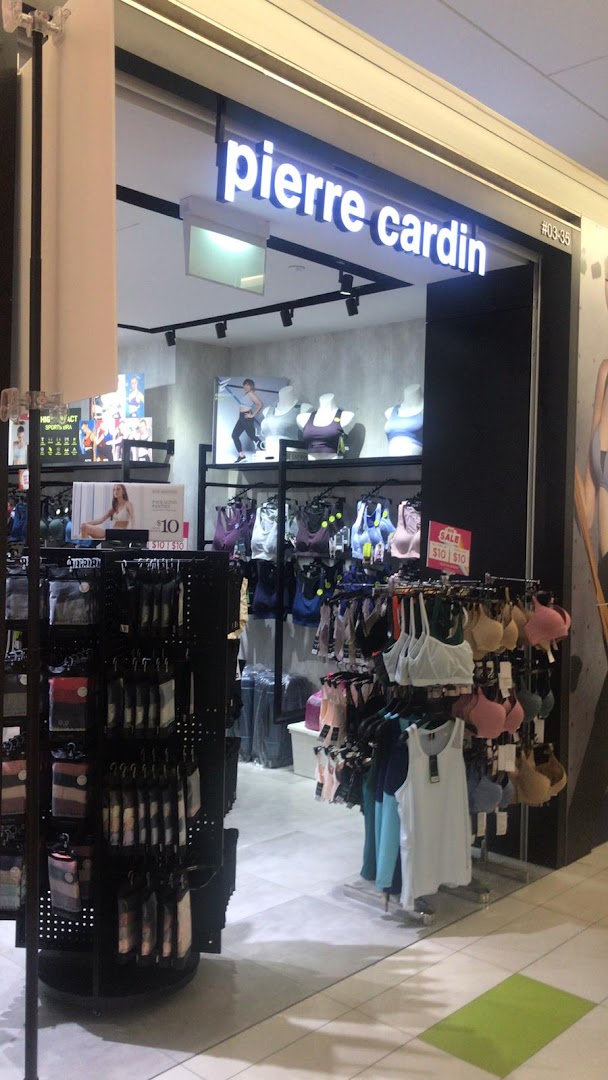 The image shows the brightly lit entrance of Pierre Cardin Lingerie, displaying various bras and undergarments.