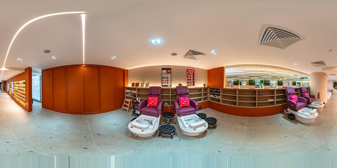 A bright and inviting interior of Pixie Nail Spa featuring comfortable pedicure chairs and product displays.