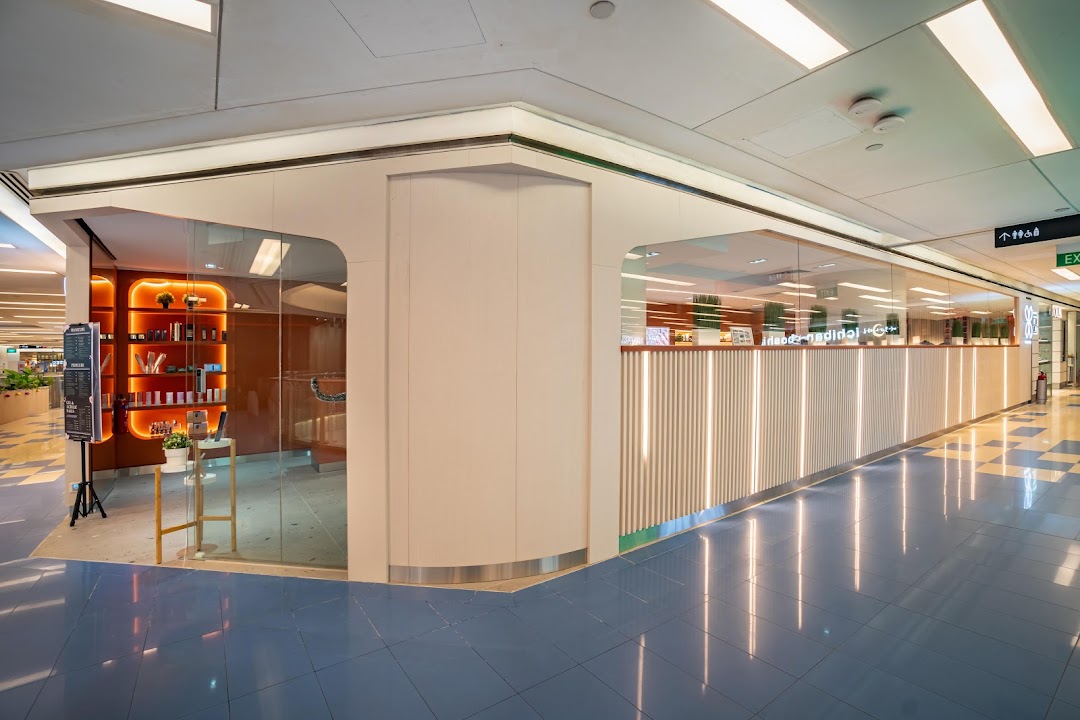 A modern and inviting Pixie Nail Spa storefront with glass walls and warm interior lighting at Clementi Mall.