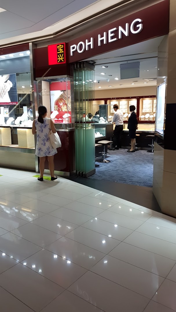 The entrance of Poh Heng Jewellery, showcasing display cases and staff assisting customers inside the elegant store.