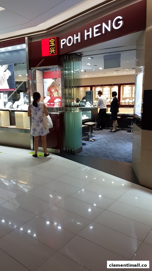 The entrance of Poh Heng Jewellery, showcasing display cases and staff assisting customers inside the elegant store.