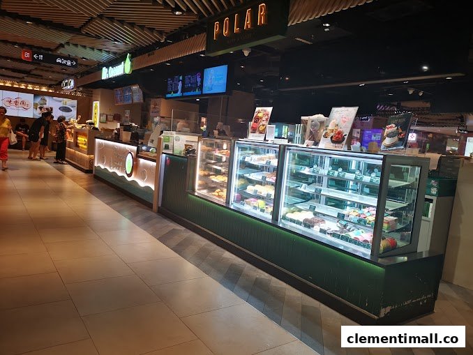 A vibrant bakery counter at Polar Puffs & Cakes, showcasing a variety of delicious pastries and cakes.