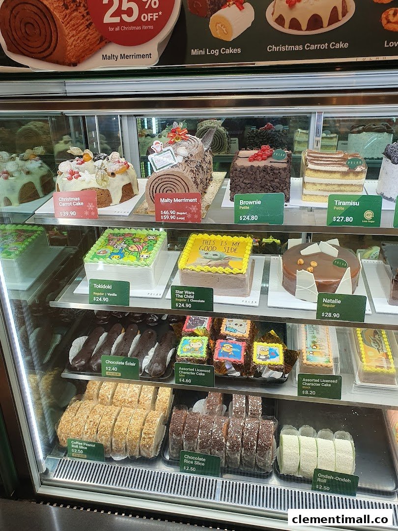 A refrigerated display case showcasing a wide variety of cakes, pastries, and desserts.
