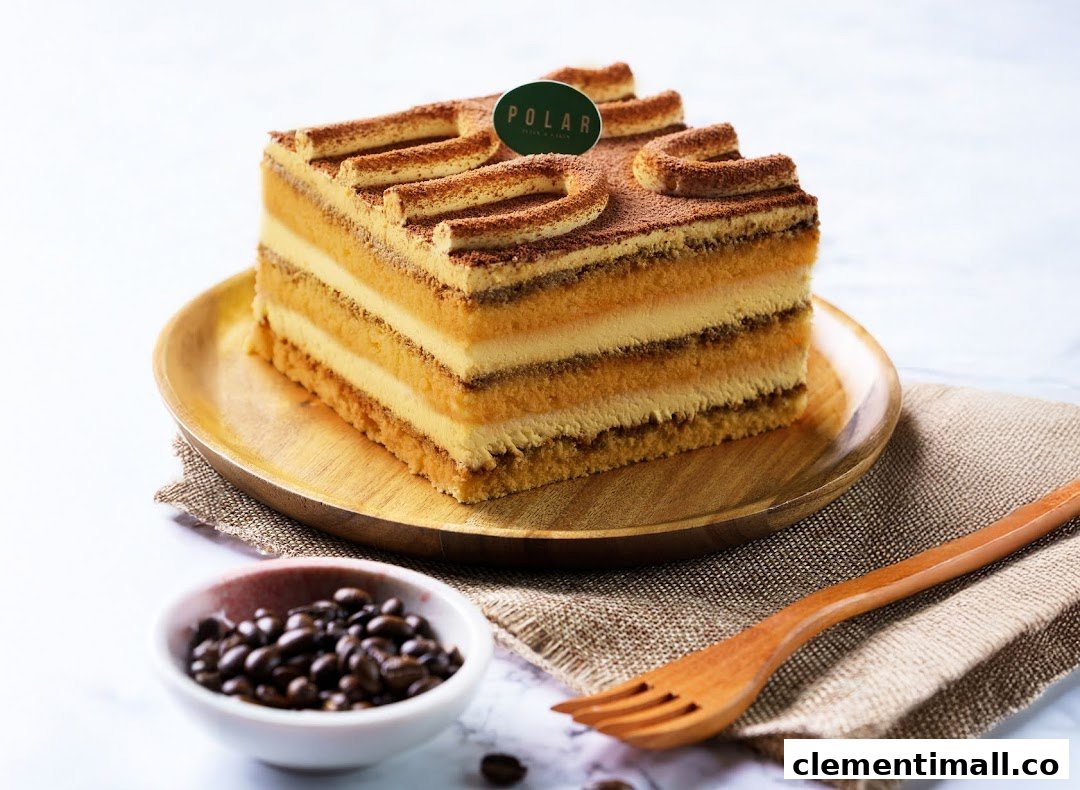 A delicious multi-layered cake with cocoa powder and a Polar brand tag, presented on a wooden plate.